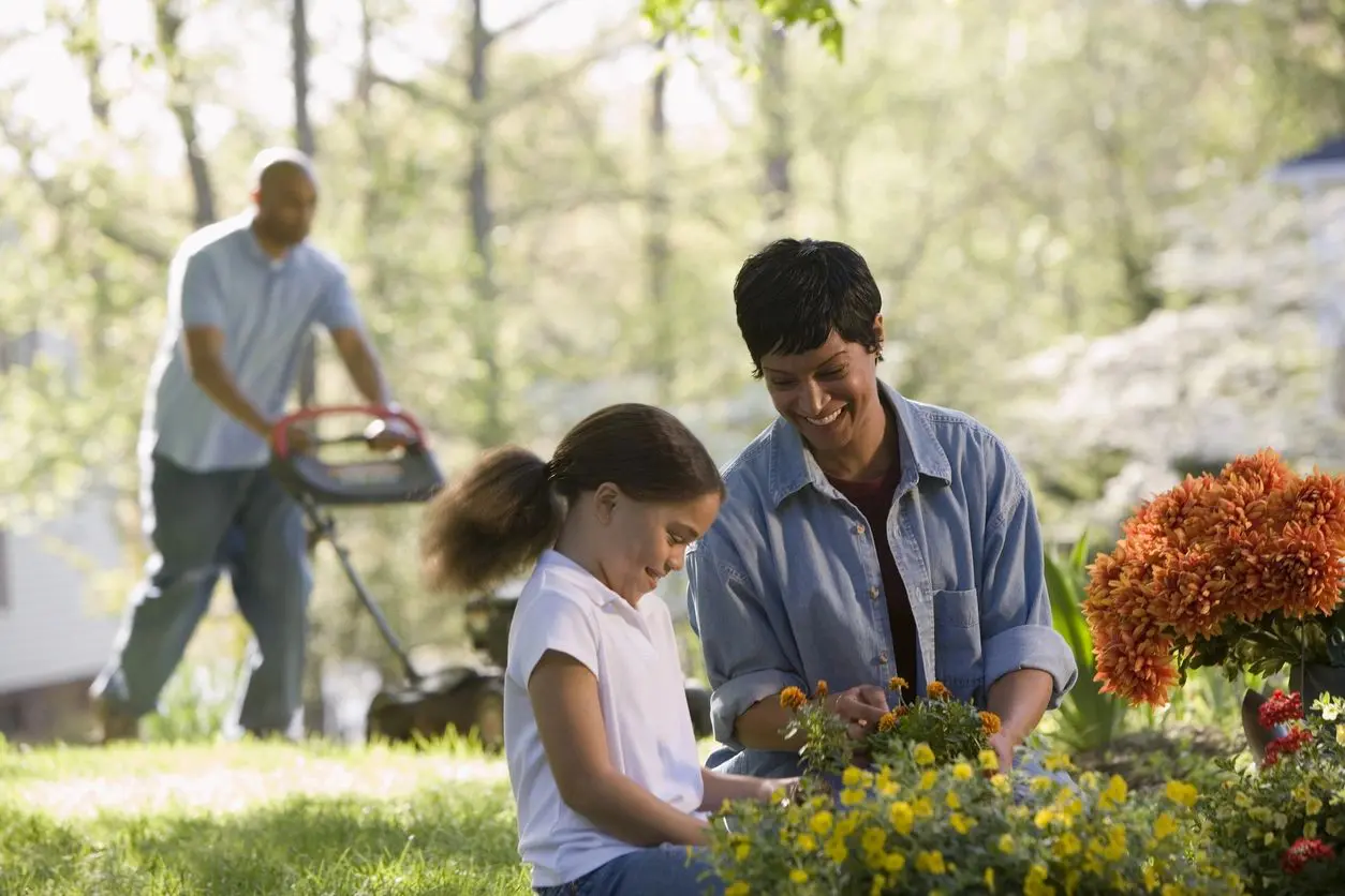 Happy family working on their lawn